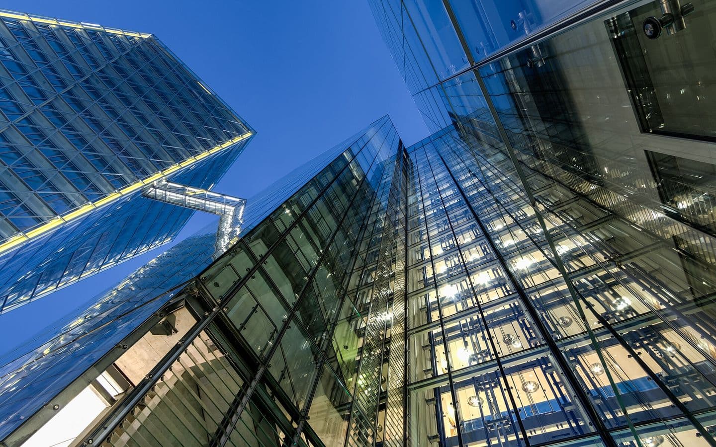 Upward view of a modern glass office building facade